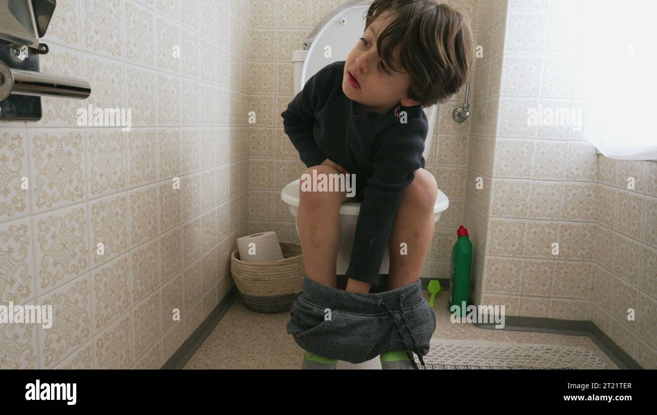 One cute little boy sitting on toilet seat. child doing his hygiene needs Stock Photo Alamy