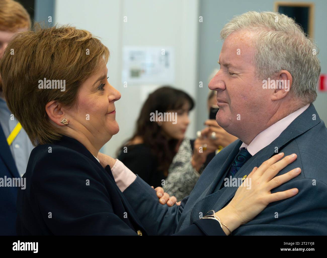 Aberdeen, Scotland, UK. 16th October 2023.  Day two of the SNP annual conference and former First Minister Nicola Sturgeon makes an appearance. A media frenzy followed before she made her way into the conference venue to listen to the afternoon’s proceedings. Nicola Sturgeon greets Ian Blackford MP. Iain Masterton/Alamy Live News Stock Photo