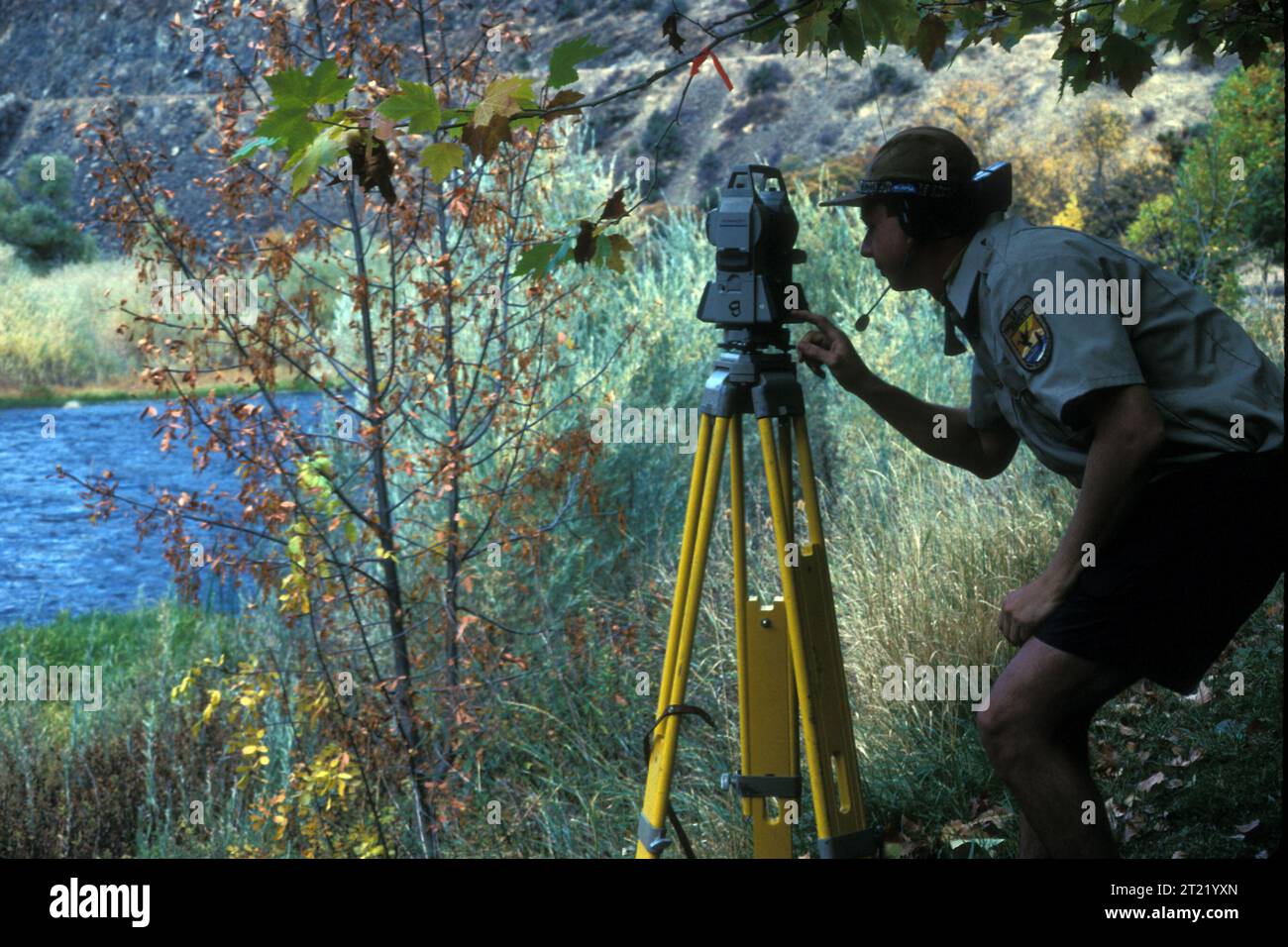 A U.S. Fish and Wildlife employee surveys the land. Subjects Employees