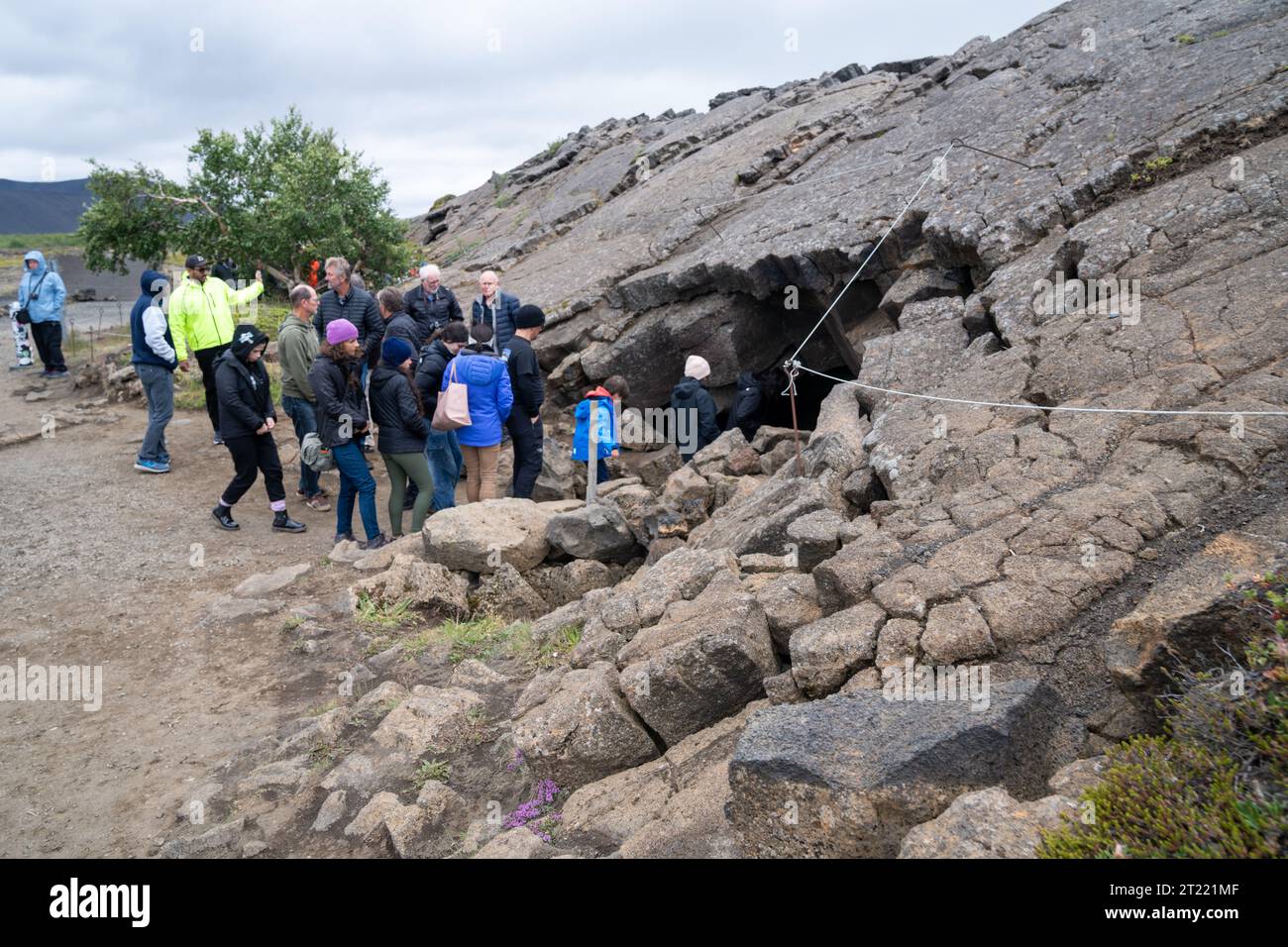 Myvatn, Iceland - July 4, 2023: Tourists head into the Grjotagja Cave, a former bathing spot in northern Iceland Stock Photo