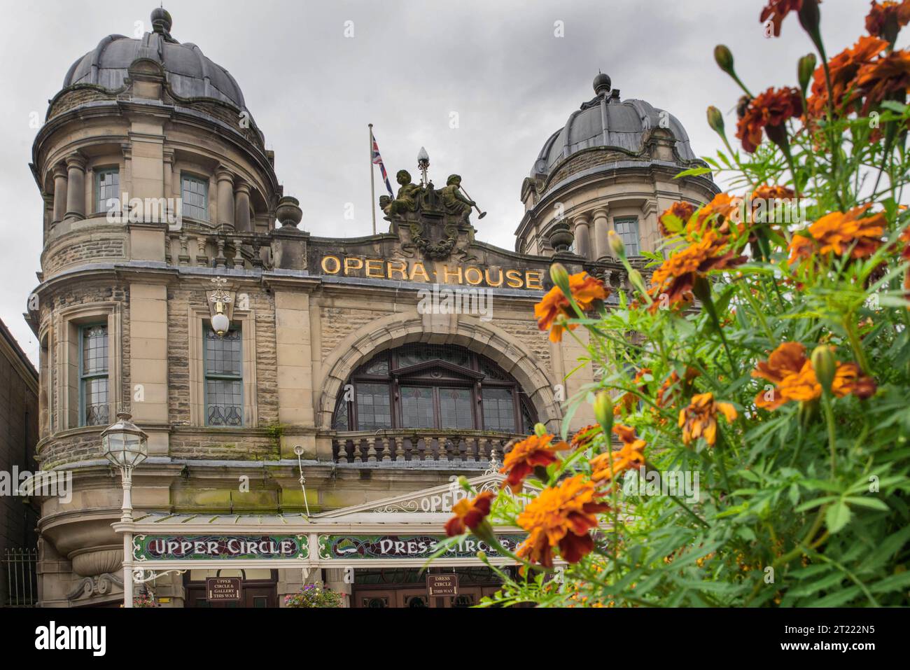 Buxton Opera House in the spa town of Buxton, Derbyshire, England, with orange French marigolds in the foreground. Stock Photo