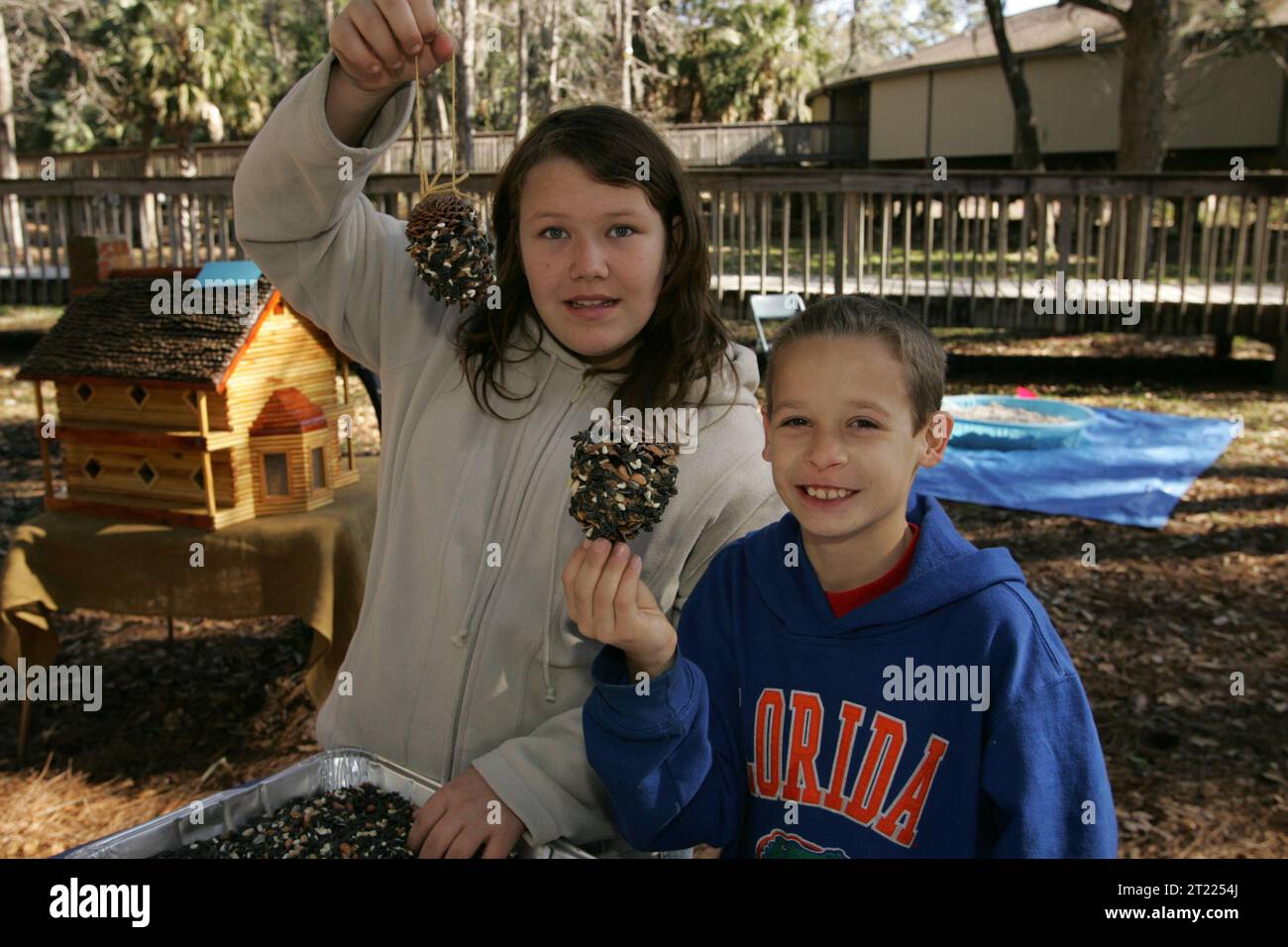Children showing their new bird feeders from the Craft fair at St. Marks National Wildlife Refuge Visitor Center. Subjects: Buildings, facilities and structures; Celebrations; Children; Crafts; Events; Exhibitions; Exhibits; Recreation; Structures; Tourism; Visitor services; Wildlife refuges. Location: Florida. Fish and Wildlife Service Site: ST. MARKS NATIONAL WILDLIFE REFUGE. Stock Photo