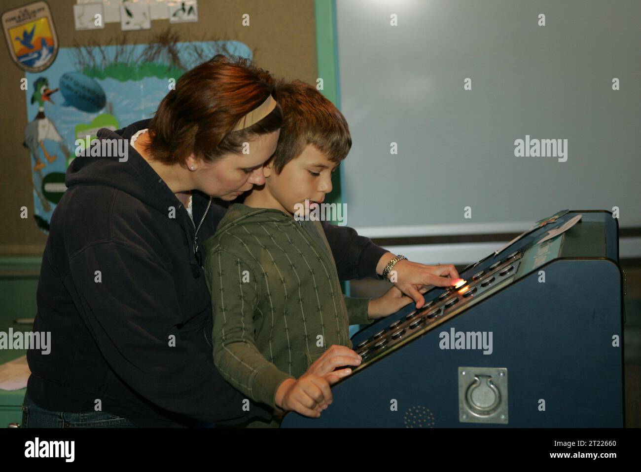 A mother and son view an exhibit at the Big Branch Marsh National ...