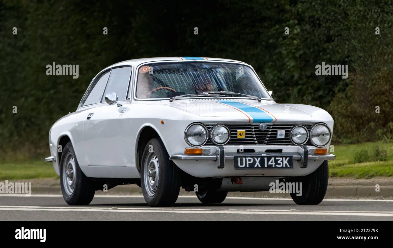 Bicester,Oxon.,UK - Oct 8th 2023: 1972 white Alfa Romeo GTV  classic car driving on an English country road. Stock Photo