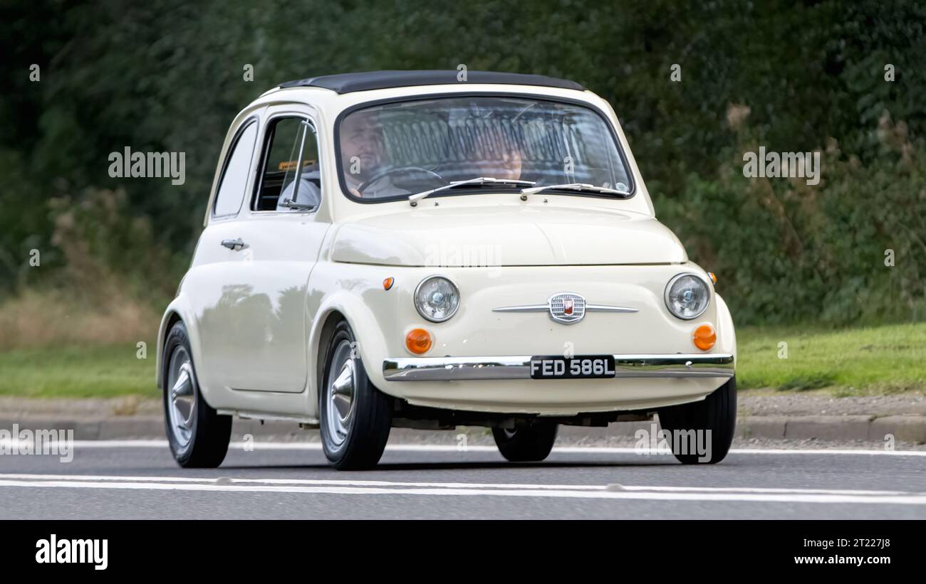 Bicester,Oxon.,UK - Oct 8th 2023: 1972 cream Fiat 500  classic car driving on an English country road. Stock Photo