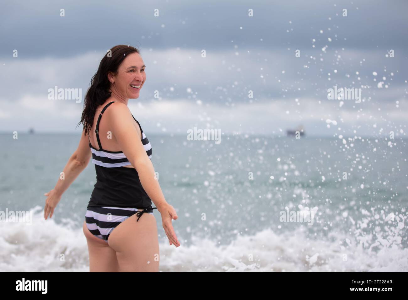 Mature woman enjoying herself on the beach Stock Photo - Alamy