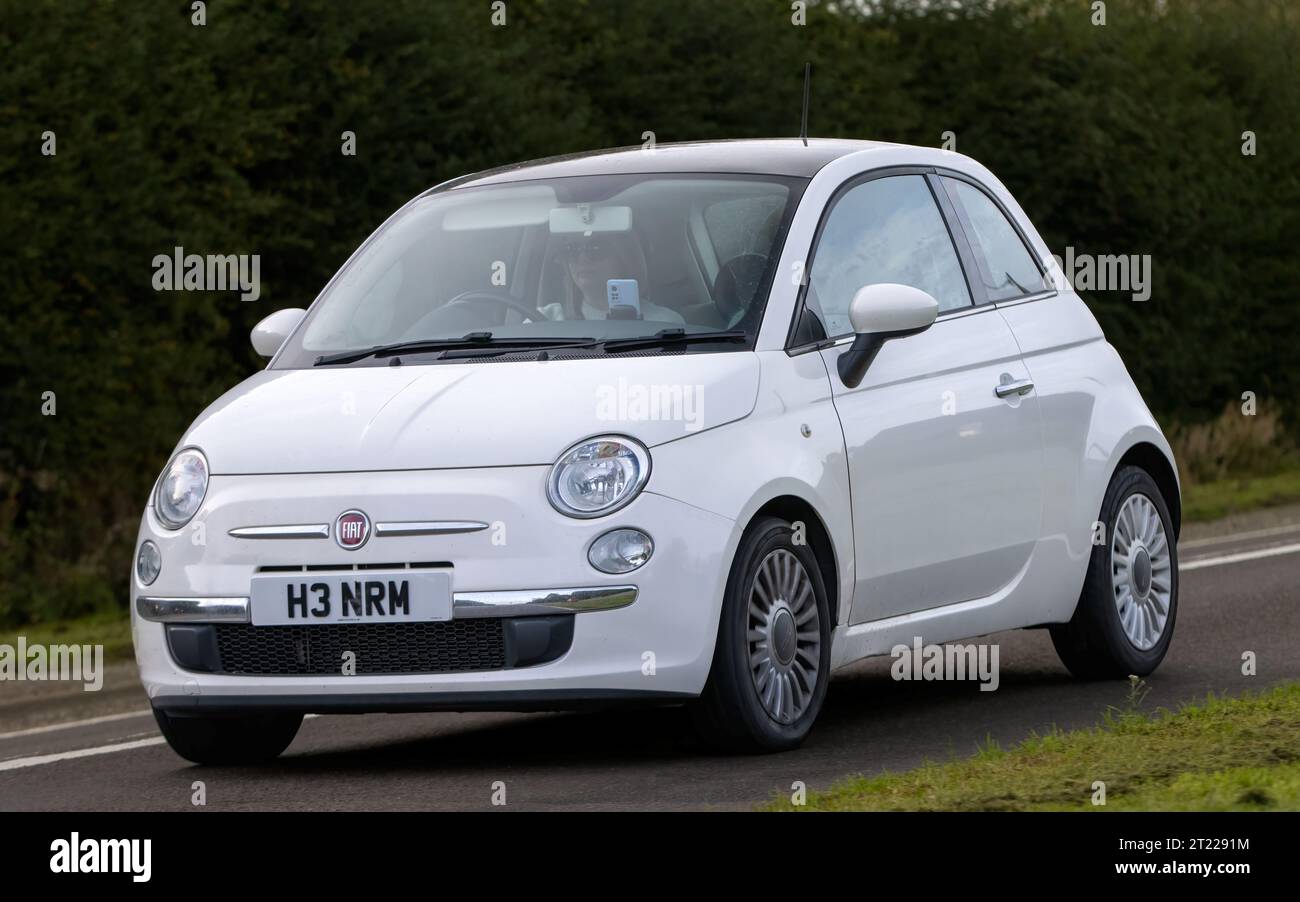 Bicester,Oxon.,UK - Oct 8th 2023: 2013 white Fiat 500  classic car driving on an English country road. Stock Photo