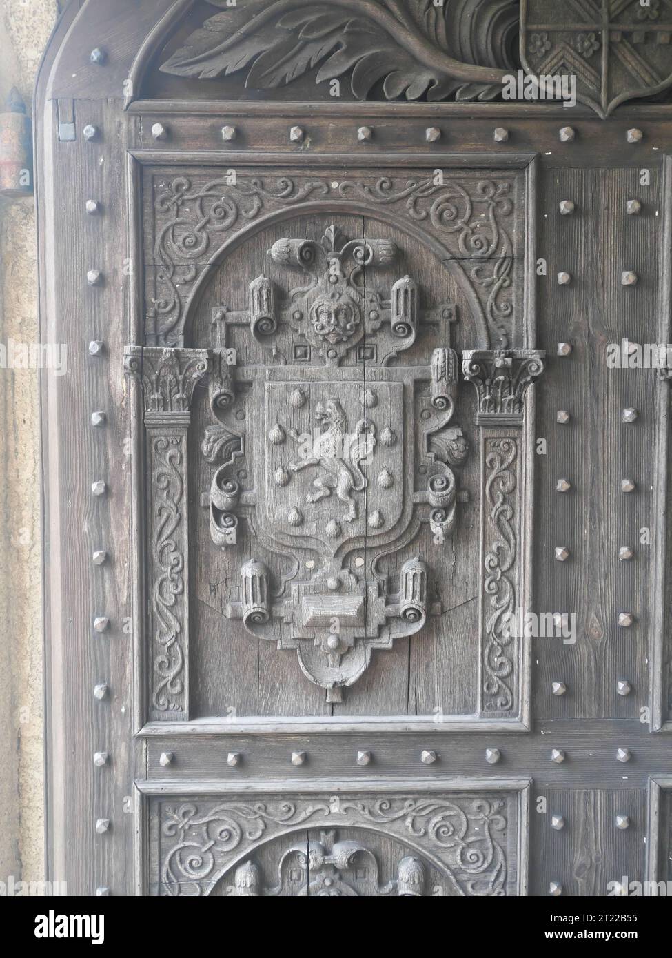 Detail of wooden door with coat of arms at the entrance to Lanhydrock manor house in Cornwall England Stock Photo