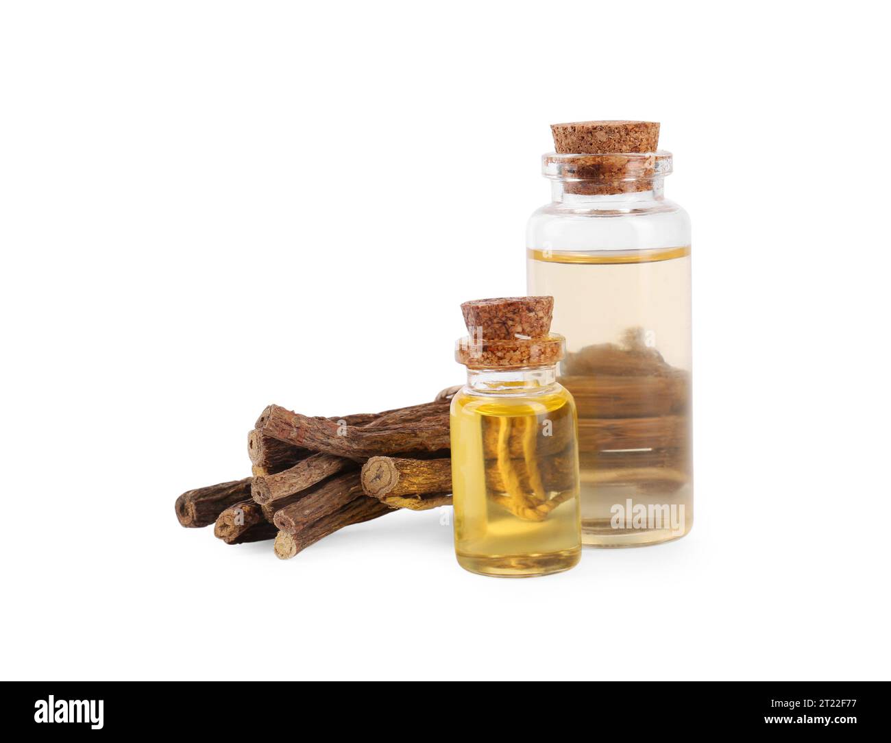 Dried sticks of licorice root and essential oil isolated on white Stock