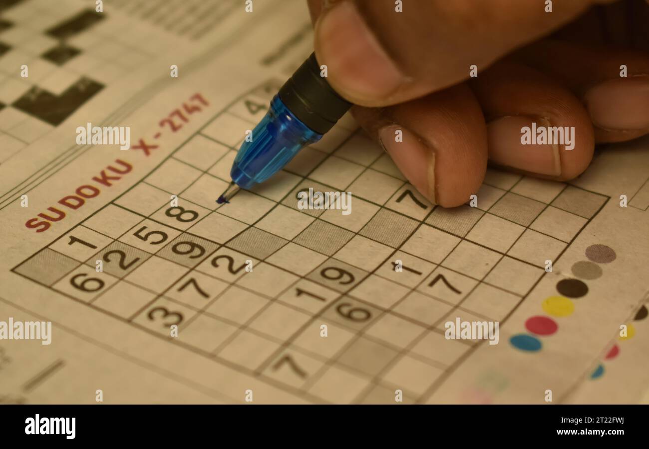 A closeup picture of Sudoku game with a pen nib on it. It was first published in a french newspaper as a numerical puzzle. Stock Photo