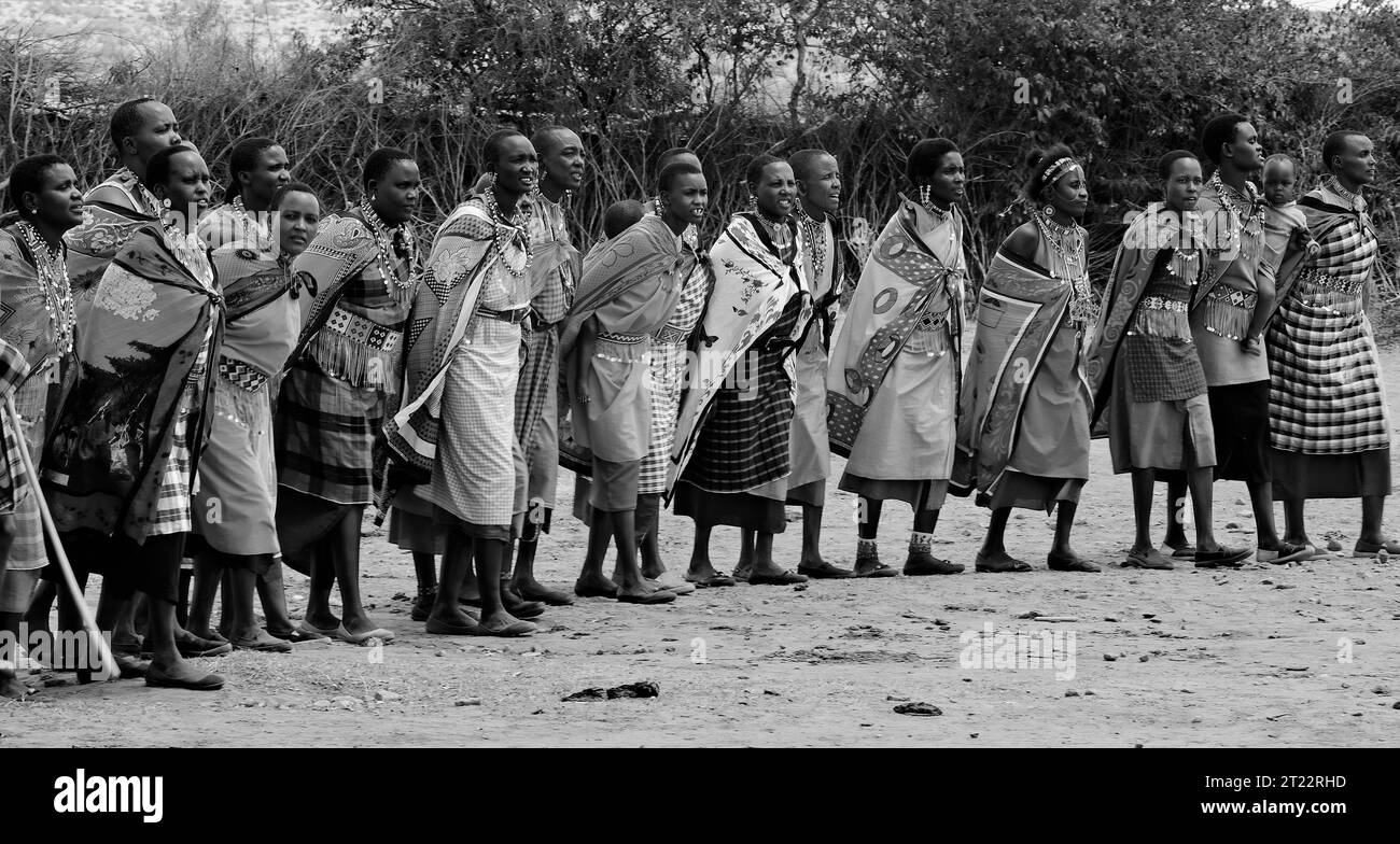 Tribal people of Maasai Mara singing, dancing and entertaining the visitors with their traditional customs in their village Stock Photo
