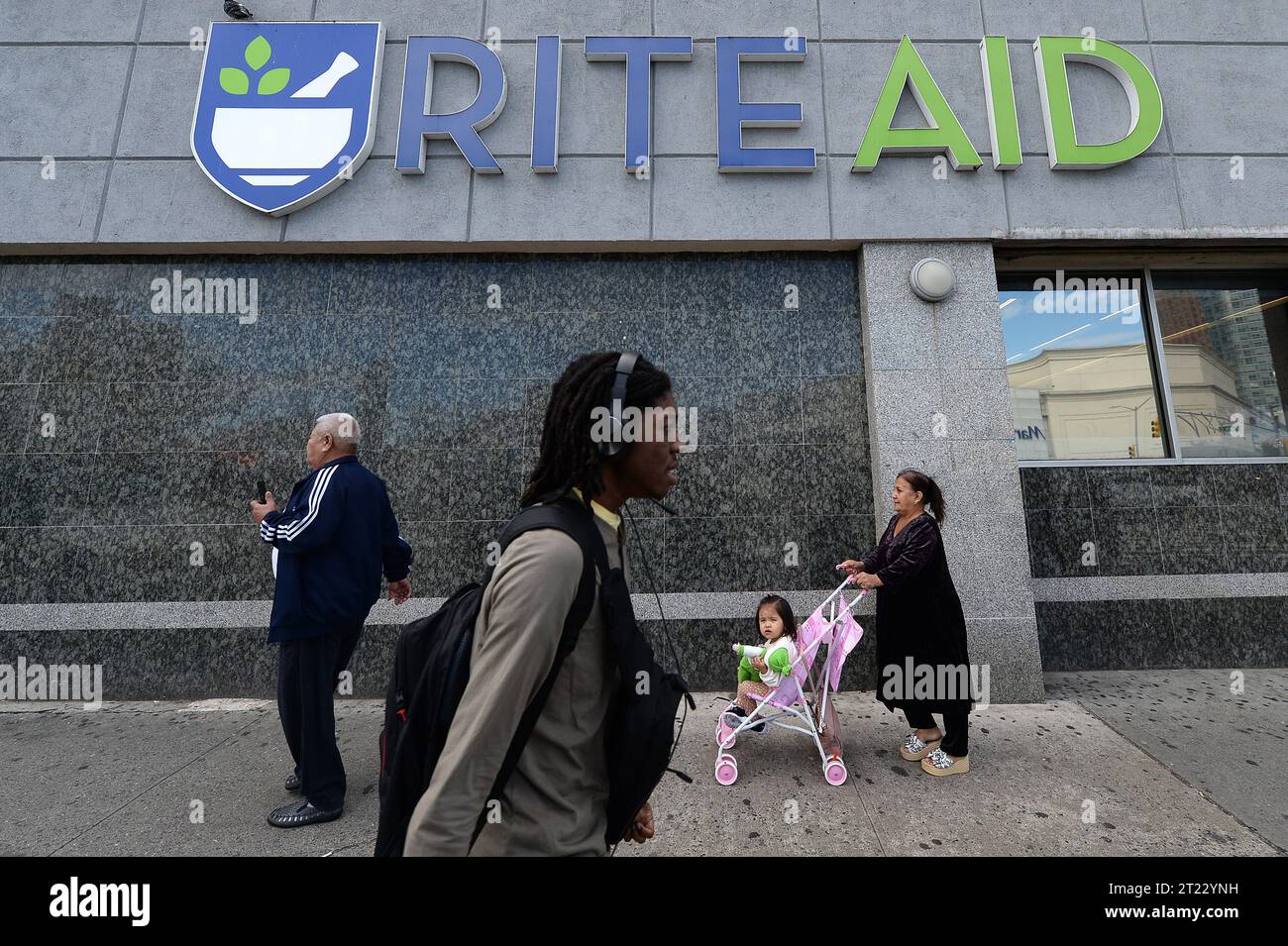 New York, USA. 16th Oct, 2023. People walk past a Rite Aid retail store and pharmacy in the Queens borough of New York City, NY, October 16, 2023. Rite Aid filed for bankruptcy protection and set to close 2,100 store and pharmacys after not being able to find funds to settle lawsuits alleging it oversupplied prescription painkillers. (Photo by Anthony Behar/Sipa USA) Credit: Sipa USA/Alamy Live News Stock Photo