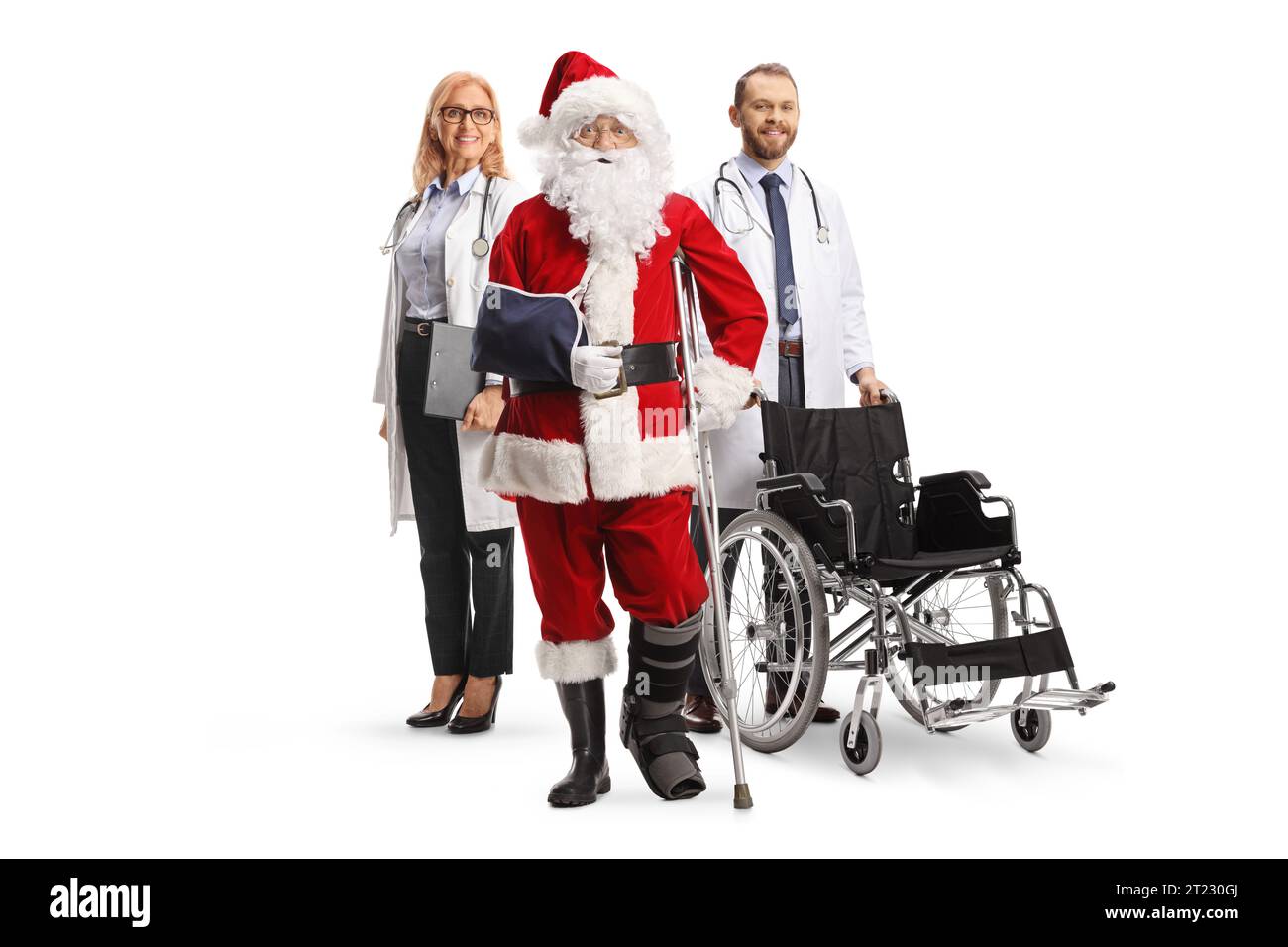 Injured santa claus with a foot brace and arm sling standing with a male and female doctors with a wheelchair isolated on white background Stock Photo