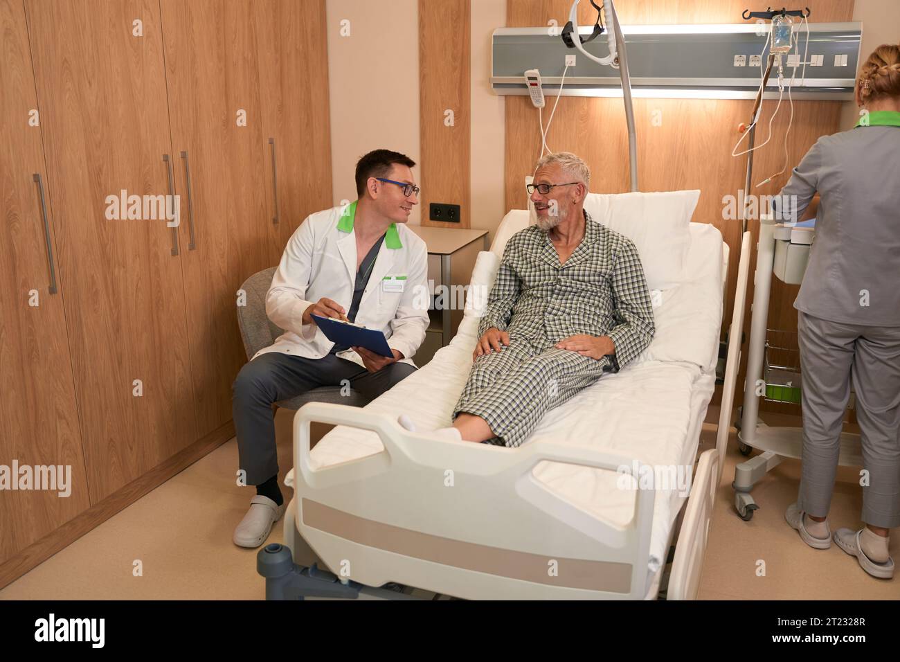 Elderly man talks doctor hi-res stock photography and images - Alamy