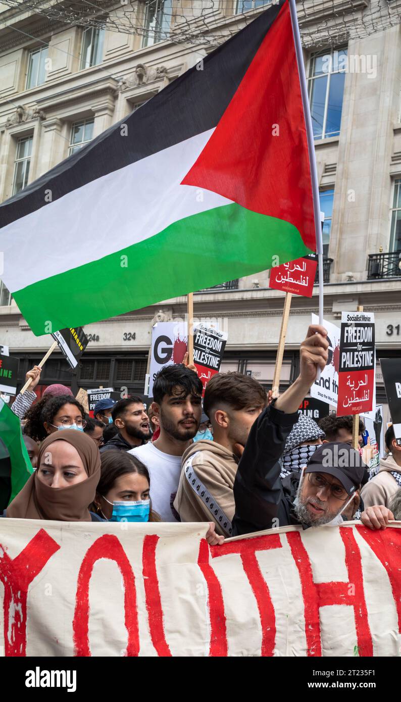 London, UK. 14 Oct 2023: Pro-Palestinian protesters march with placards and flags in central London, UK at a demonstration against Israeli attacks on Stock Photo