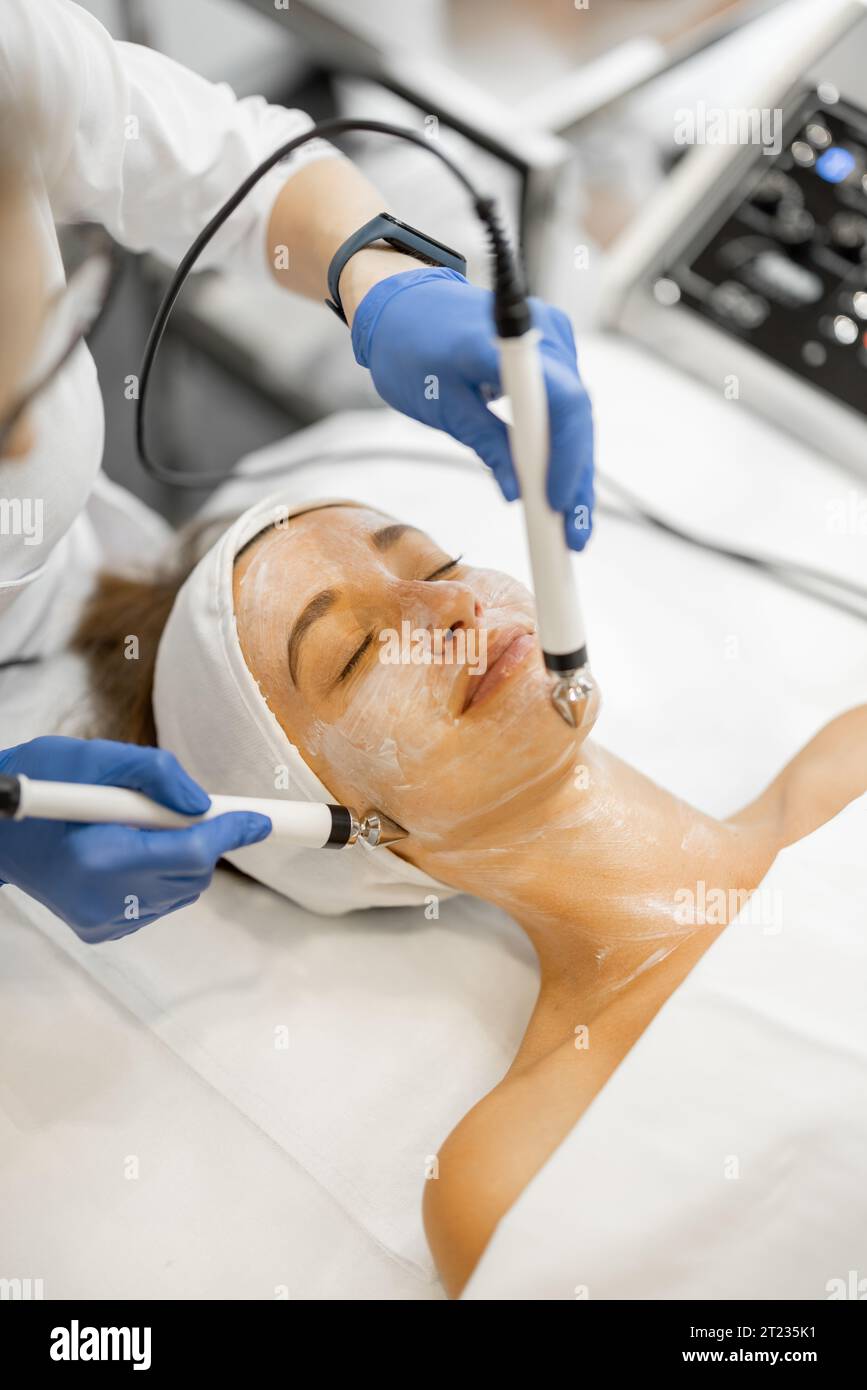 Young woman during facial microcurrent procedure Stock Photo - Alamy