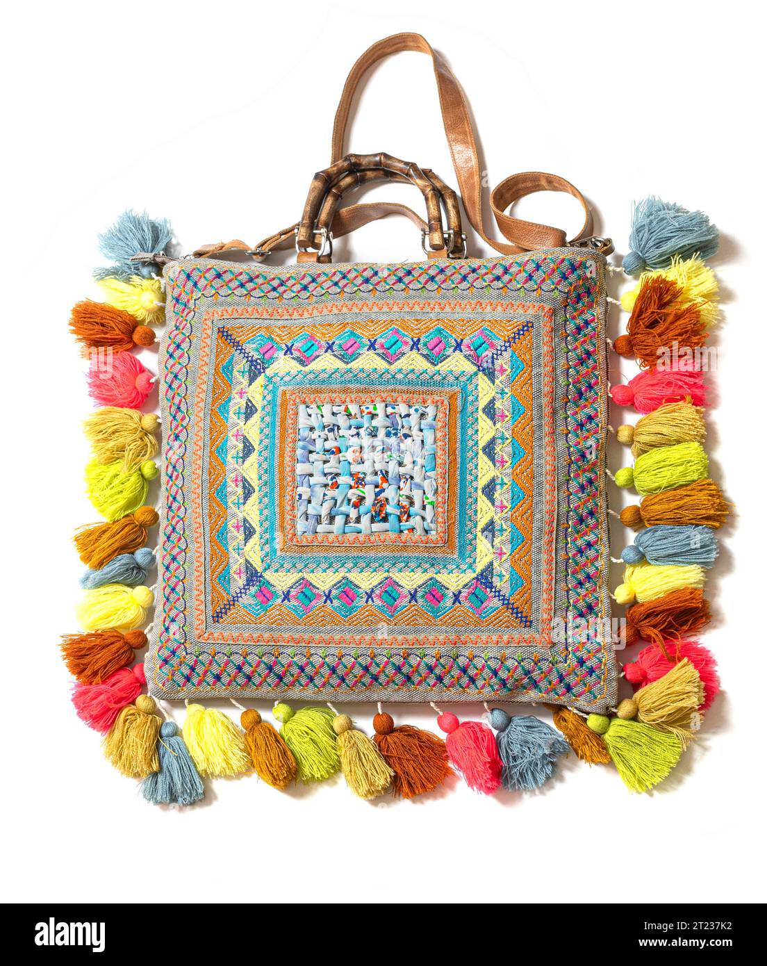 Exotic Fabric bag  with colored pompoms isolated on white background Stock Photo