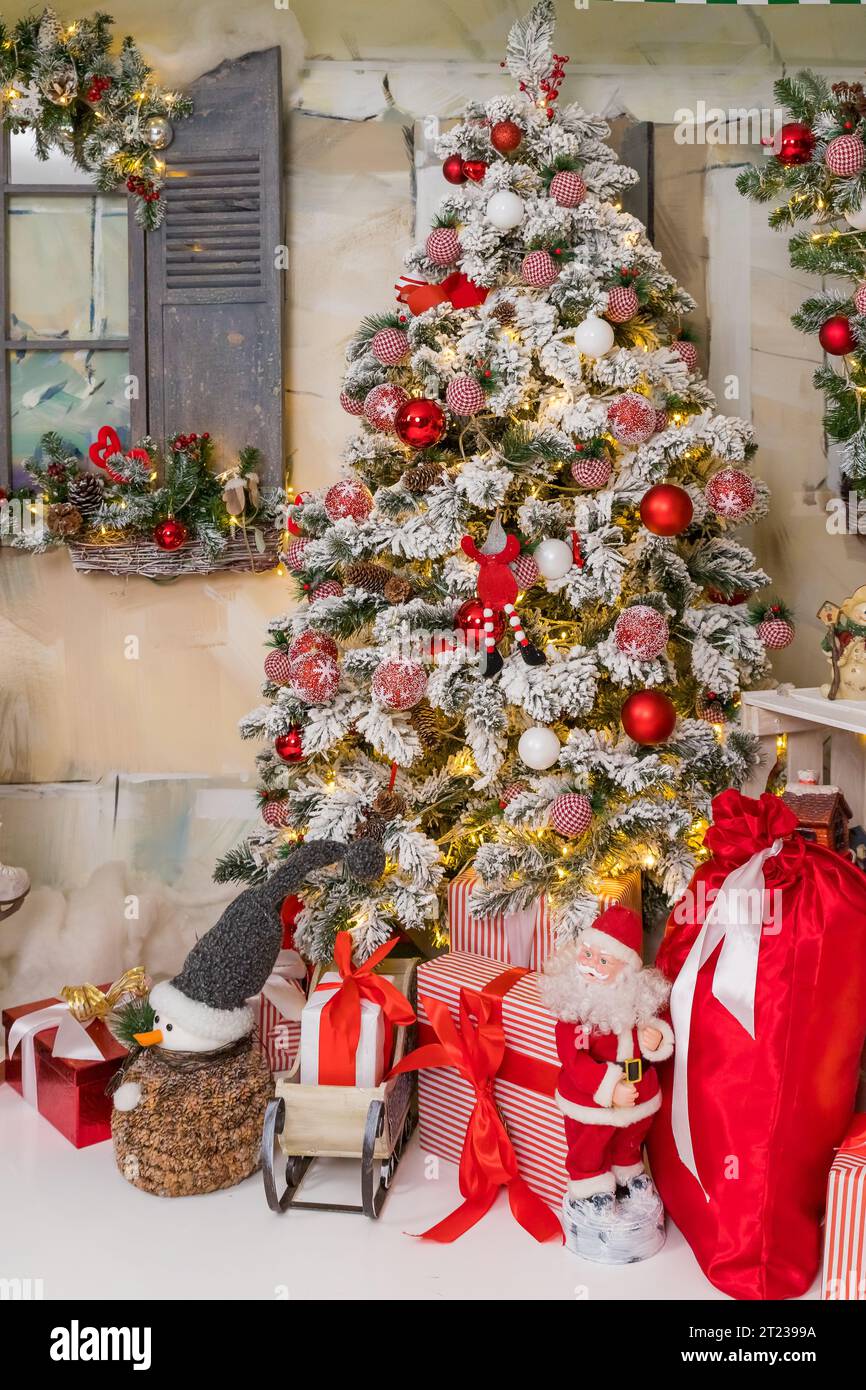 Christmas decorations. Christmas background. Beautiful holiday decorated room with Christmas tree with presents under it Stock Photo