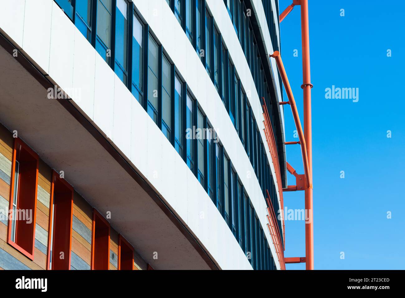White house facade with red steel details is under blue sky. Abstract modern architecture background Stock Photo