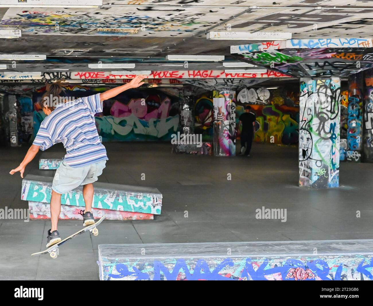 Young British skateboarder skating at London Southbank Skate Space, an urban culture landmark used by skateboarders Stock Photo