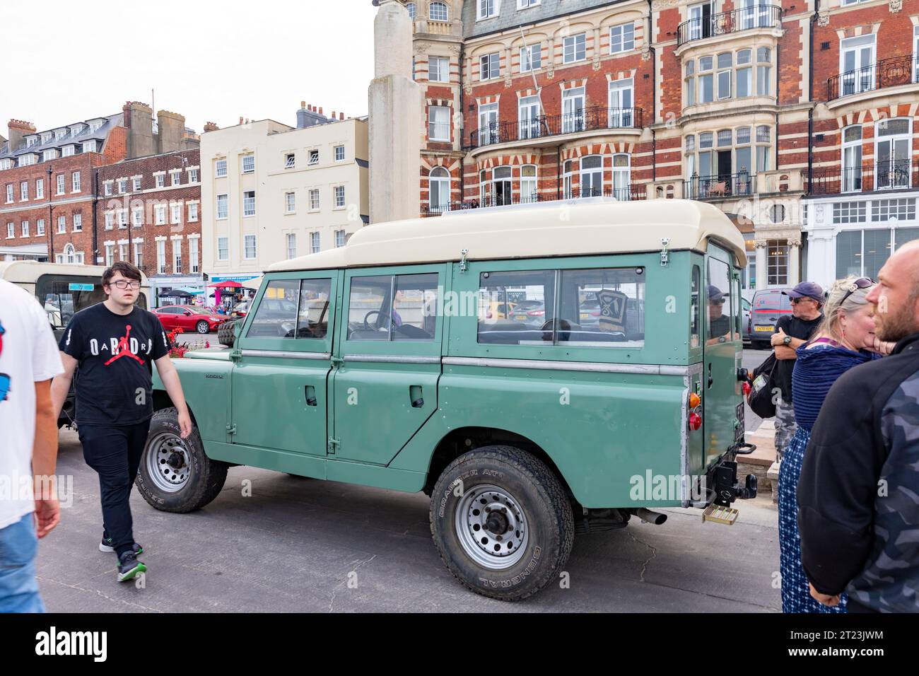 Dorset car club public event on Weymouth promenade with classic vintage Land Rover defender on display,England,UK,2023 Stock Photo