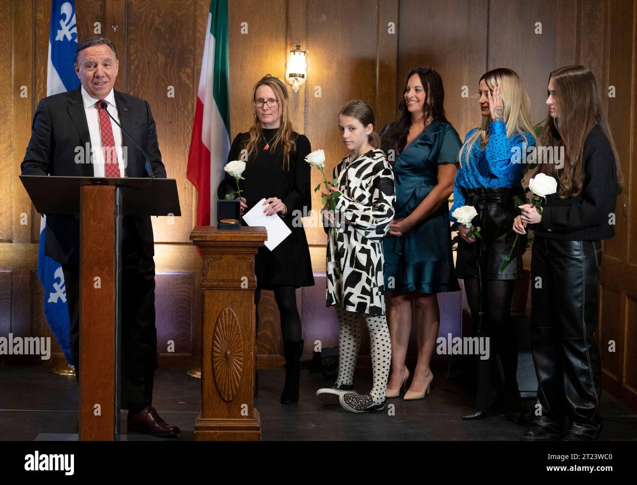 Quebec Premier Francois Legault, stands with members of the Bossy