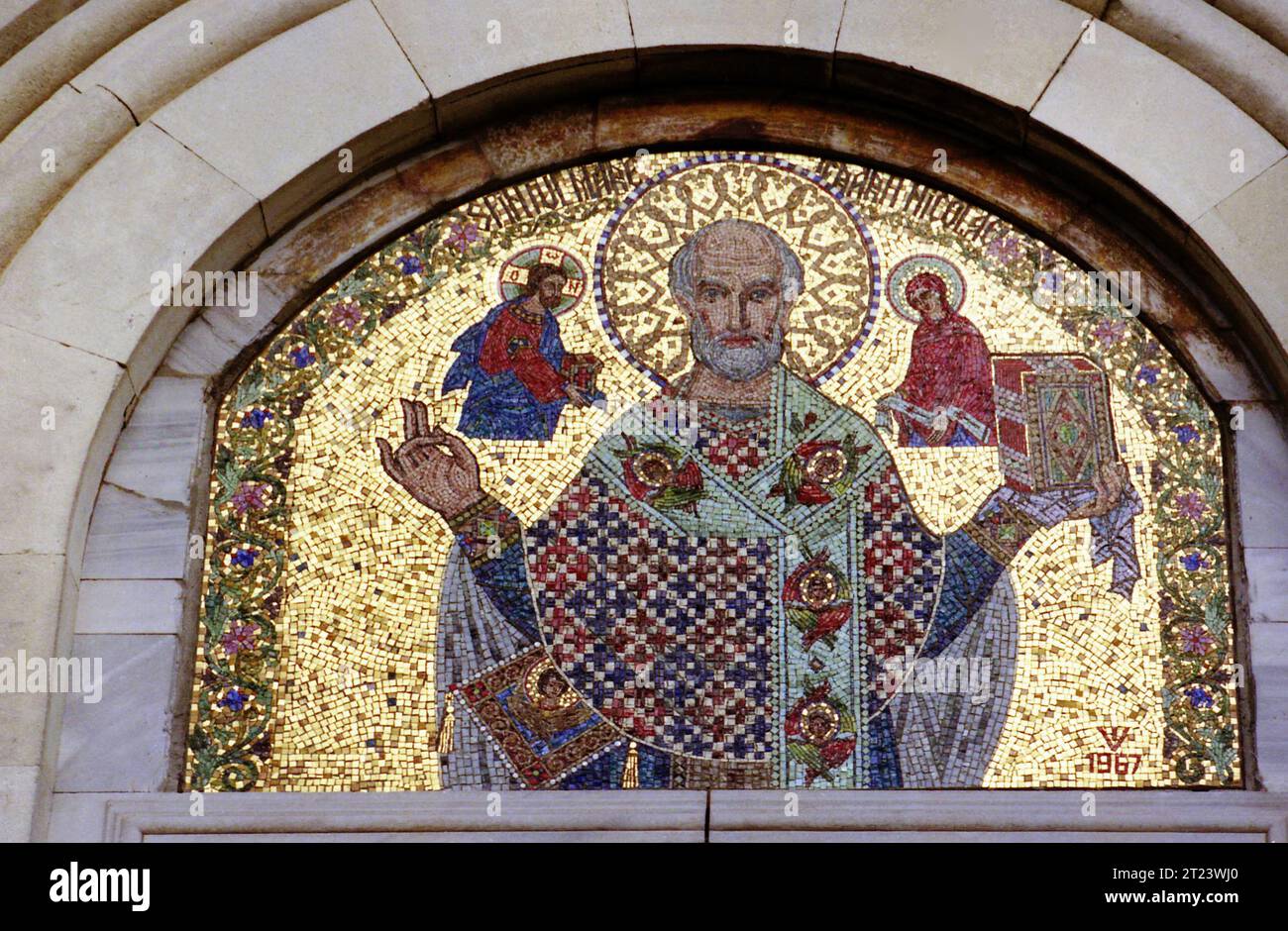 Dâmbovița County, Romania, 1991. Exterior view of St. Nicholas Church at Dealu Monastery, a historical monument from the 15th-century. Mosaic of St. Nicholas at the entrance in the church. Stock Photo