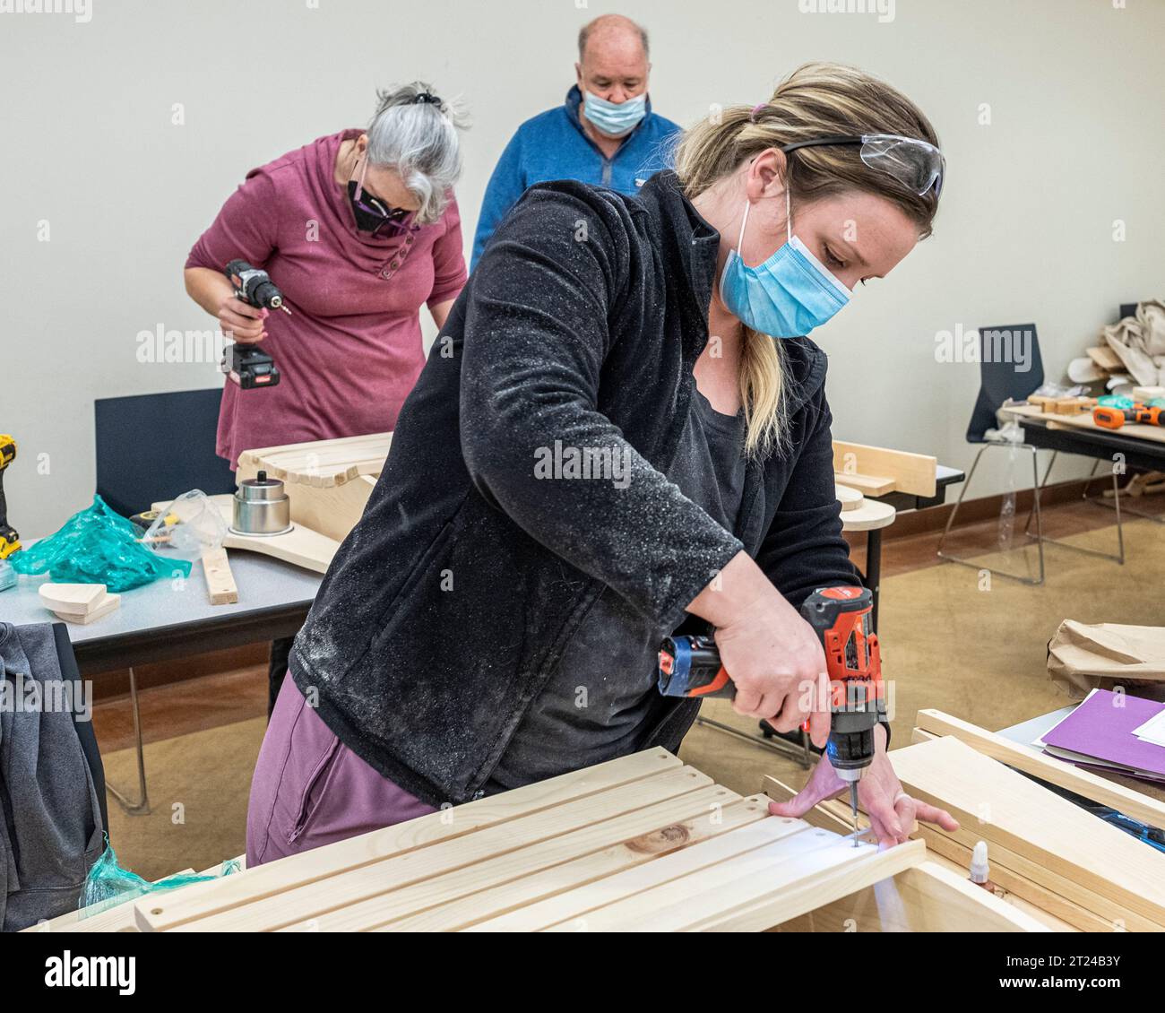 People in an adult ed woodworking class Stock Photo Alamy