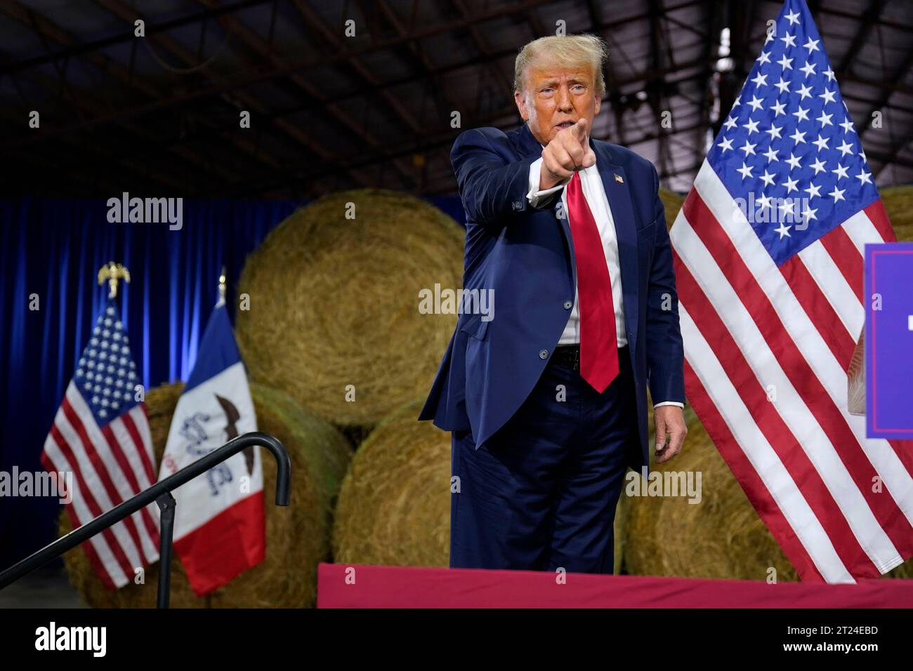 Former President Donald Trump reacts after a commit to caucus rally