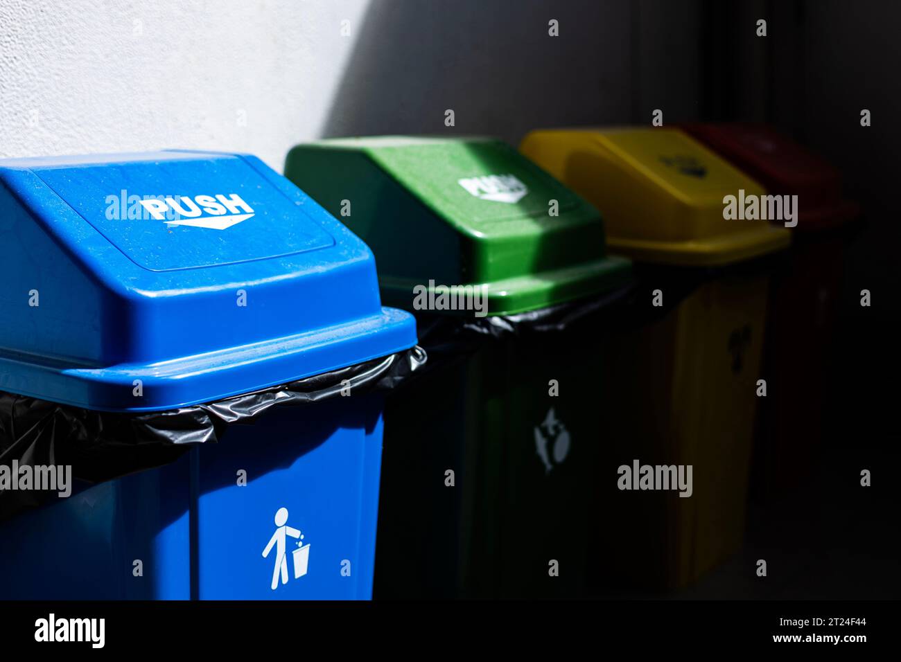 Multicolored Garbage Trash Bins. Recycle Bin on the floor and white