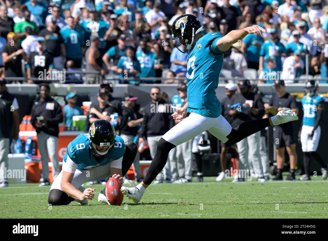 Jacksonville Jaguars place kicker Brandon McManus, right, kicks an