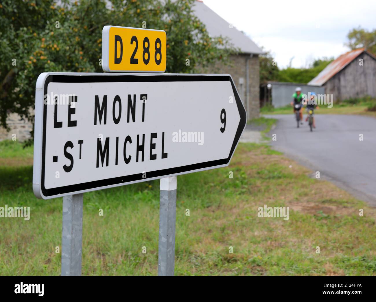 Road sign with arrow and directions to the Mont Saint Michel Abbey in Northern France Stock Photo