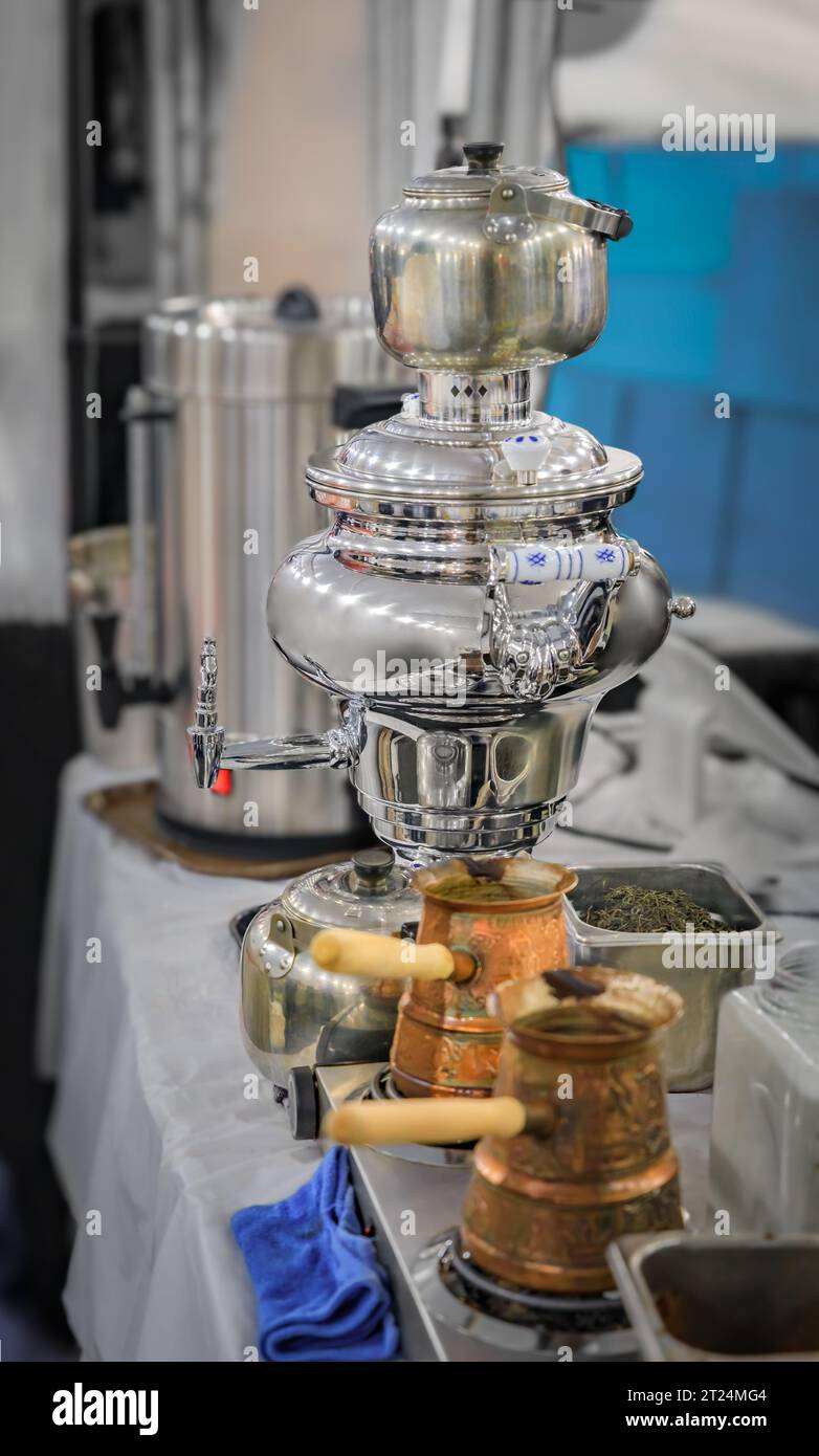 Traditional Russian samovar tea pot and Turkish cezve or ibrik copper coffee pots, at a food festival in San Francisco Stock Photo