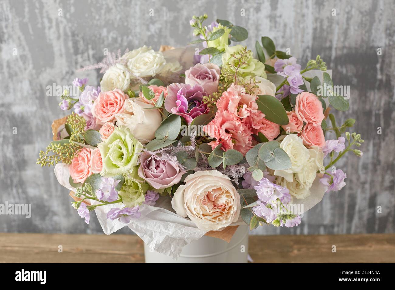 Small Beautiful bouquet of mixed flowers in woman hand. Floral shop concept . Beautiful fresh cut bouquet. Flowers delivery Stock Photo