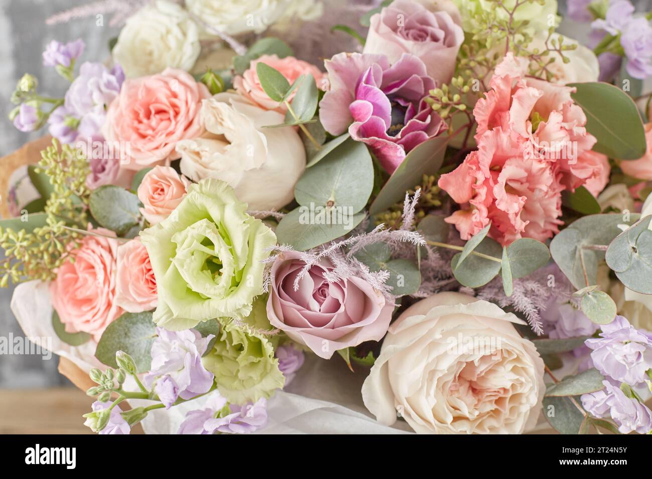 Small Beautiful bouquet of mixed flowers in woman hand. Floral shop concept . Beautiful fresh cut bouquet. Flowers delivery Stock Photo