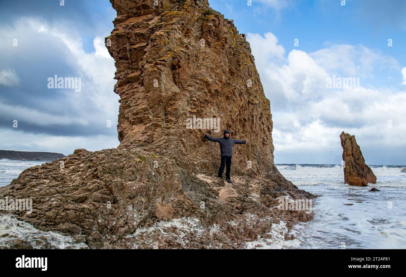 Man standing on rocks by ocean hi-res stock photography and images - Alamy