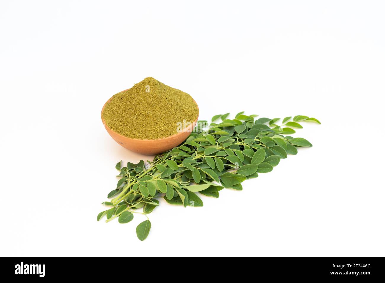 Moringa powder with leaves on white isolated background Stock Photo - Alamy