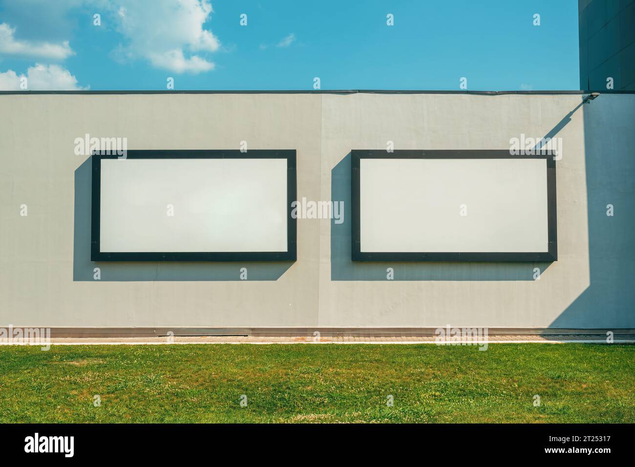 Two blank advertising billboards on the wall as mockup posters and ...