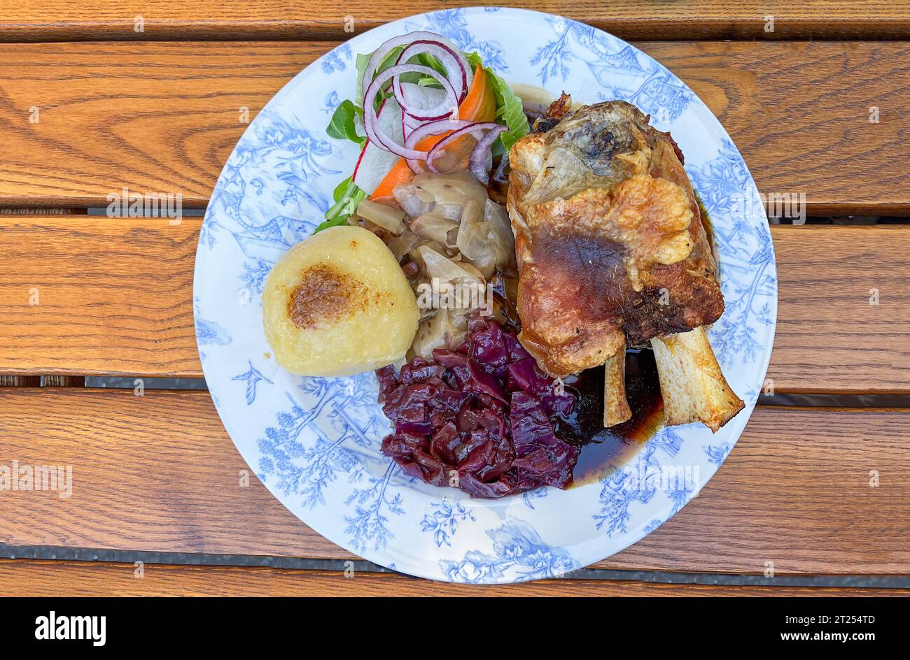 Overhead view of traditional Bavarian roast pork, potato, cabbage and salad Stock Photo