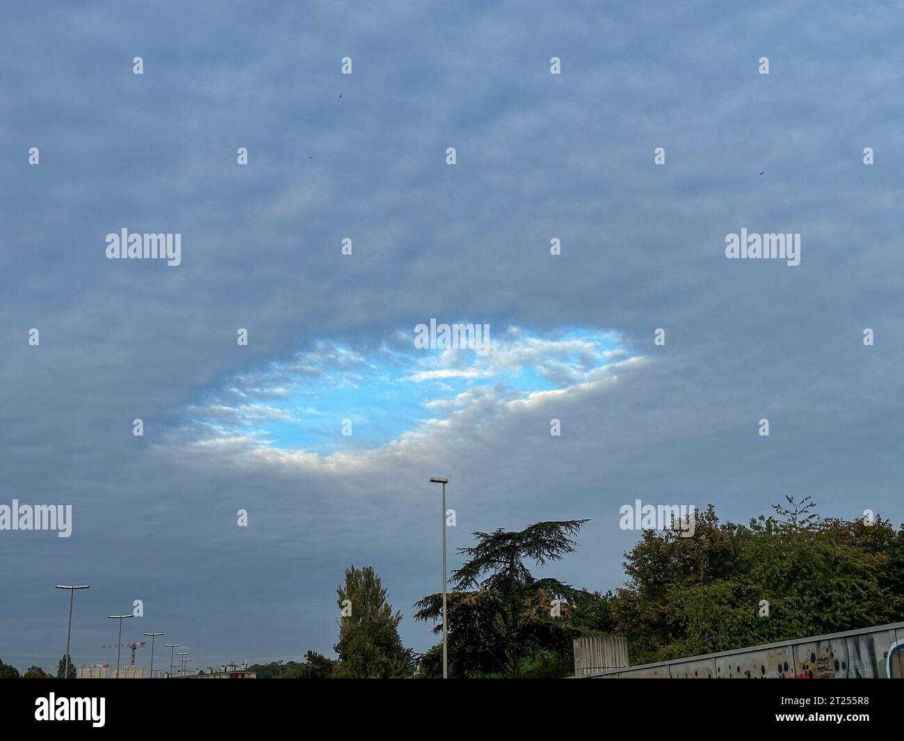 Paris, France. 16th Oct, 2023. A rare Cavum appeared in the sky above Paris, France on October 16, 2023. A Cavum (also known as a fallstreak hole or cloud hole) is a large gap, usually circular or elliptical, that can appear in cirrocumulus or altocumulus clouds. Photo by Christophe Geyres/ABACAPRESS.COM Credit: Abaca Press/Alamy Live News Stock Photo