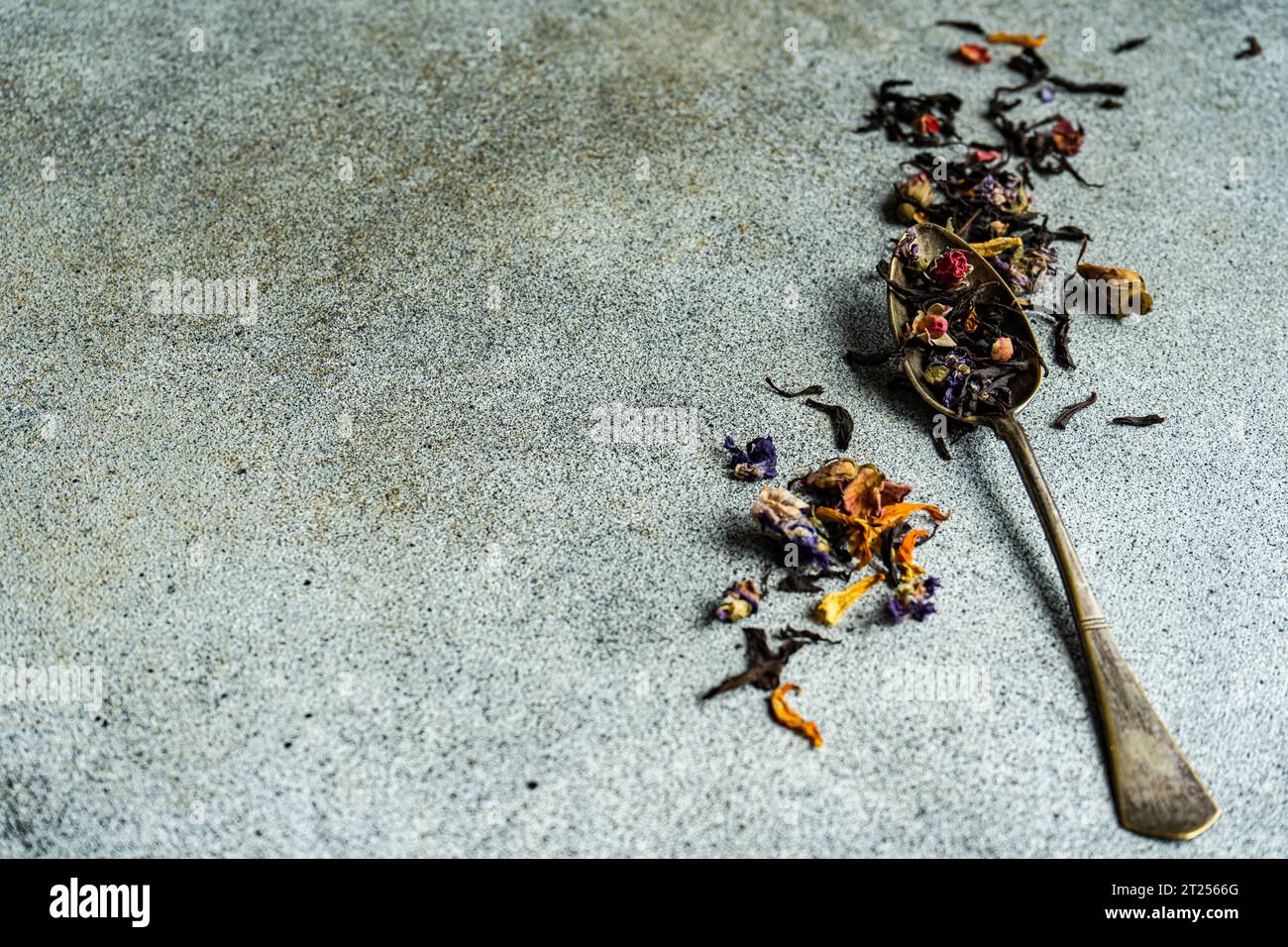 Overhead view of a vintage teaspoon with loose tea leaves Stock Photo
