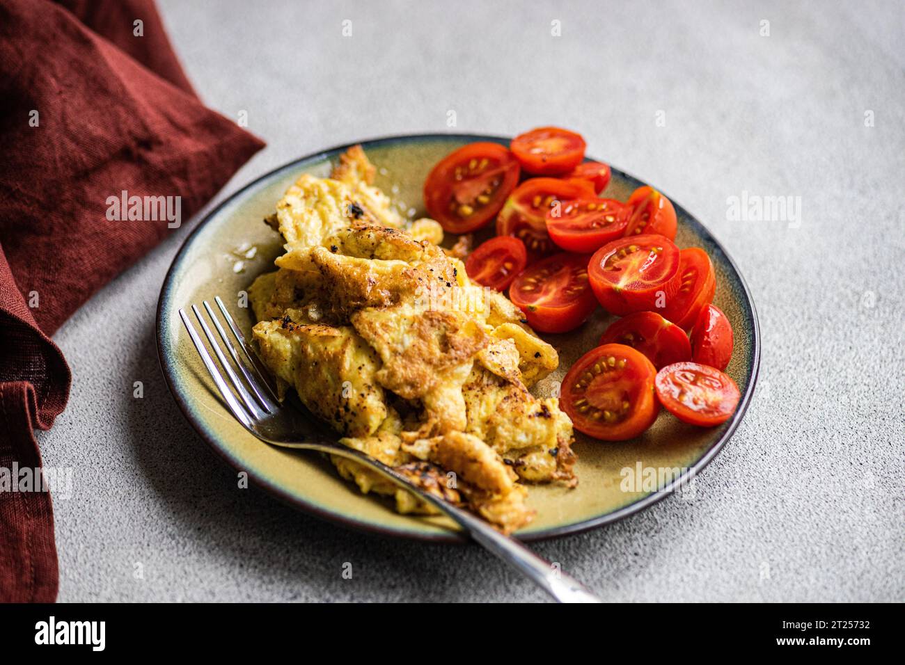 Close-up of an omelette with fresh cherry tomatoes Stock Photo