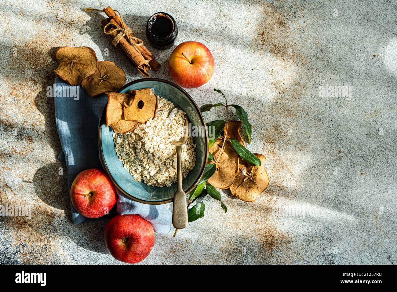 Raw oats and apples in the bowl Stock Photo