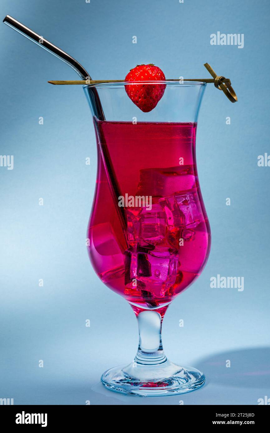 A red cocktail on a blue background with copy space Stock Photo