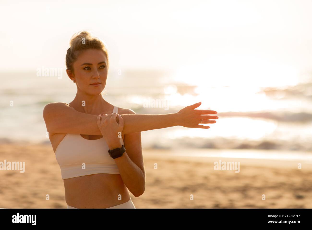 Woman beach stretching arms hi-res stock photography and images - Alamy