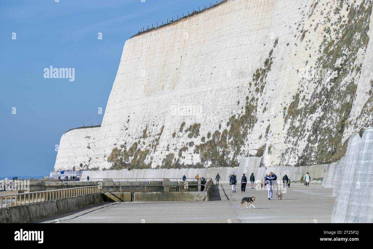 Brighton UK 17th October 2023 - Calm before Storm Babet arrives as walkers enjoy the sunshine along the undercliff walk in Saltdean near Brighton . Storm Babet is forecast to arrive in Britain from tomorrow bringing strong winds and heavy rain : Credit Simon Dack / Alamy Live News Stock Photo