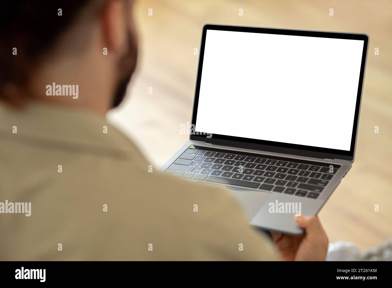 Man Using Laptop Computer With Blank White Screen Stock Photo