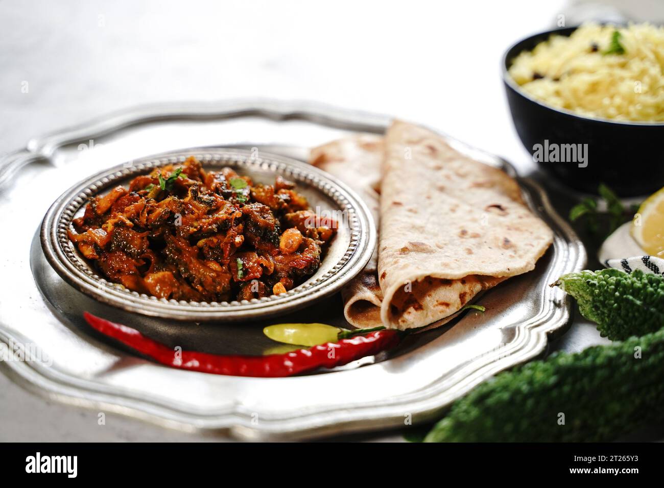 Bitter gourd curry - karela subji served with rice and roti, selective focus Stock Photo