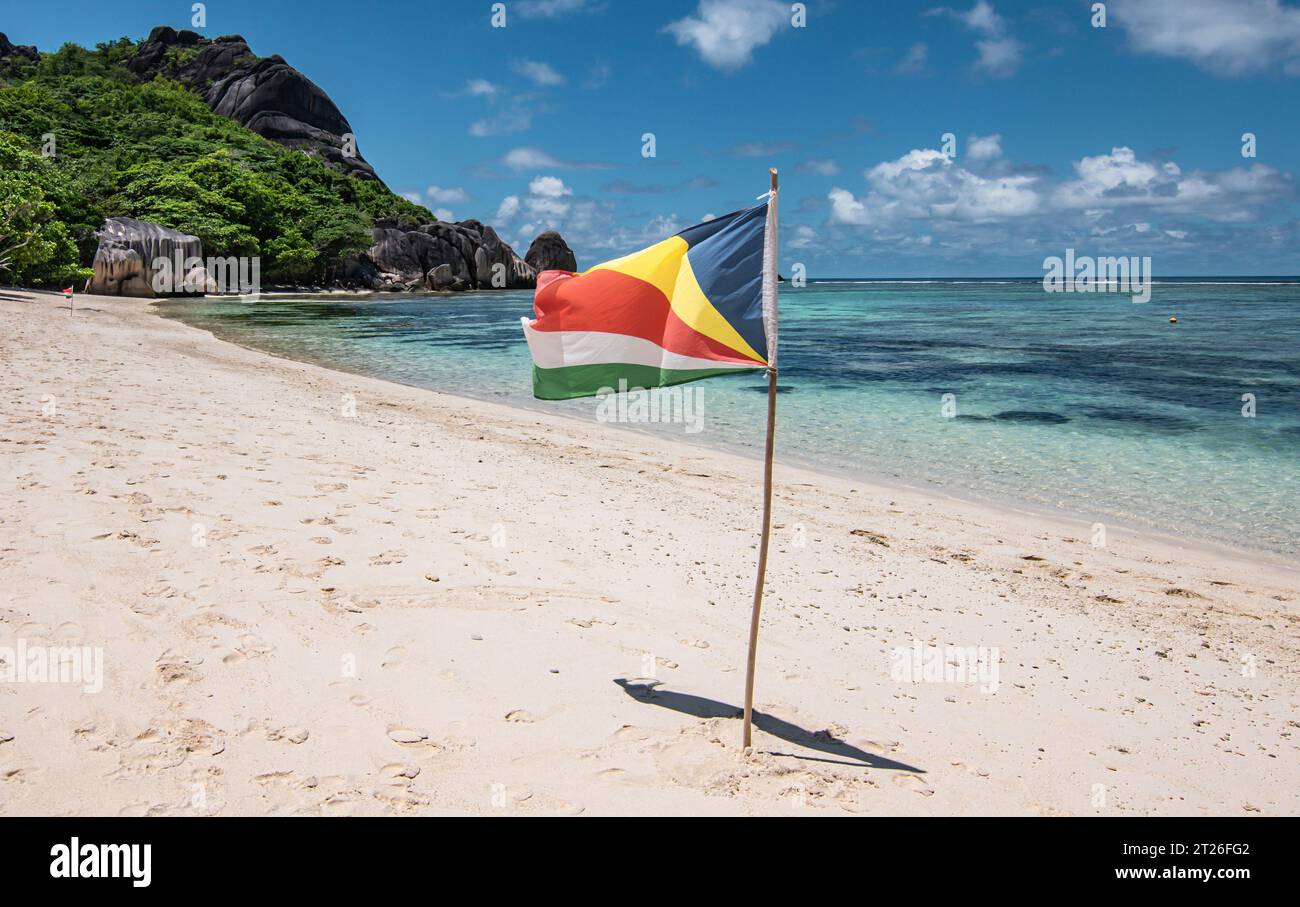 Flag of Seychelles on the beach, La Digue Island. Stock Photo