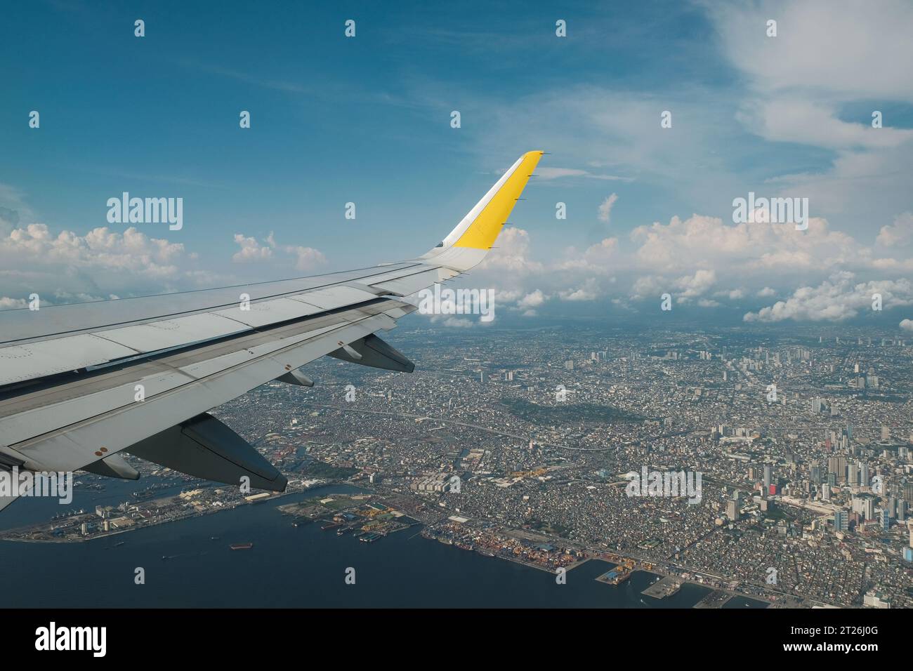 Wing From Window Of Airplane Flying Over The City Of Manila. Aerial ...